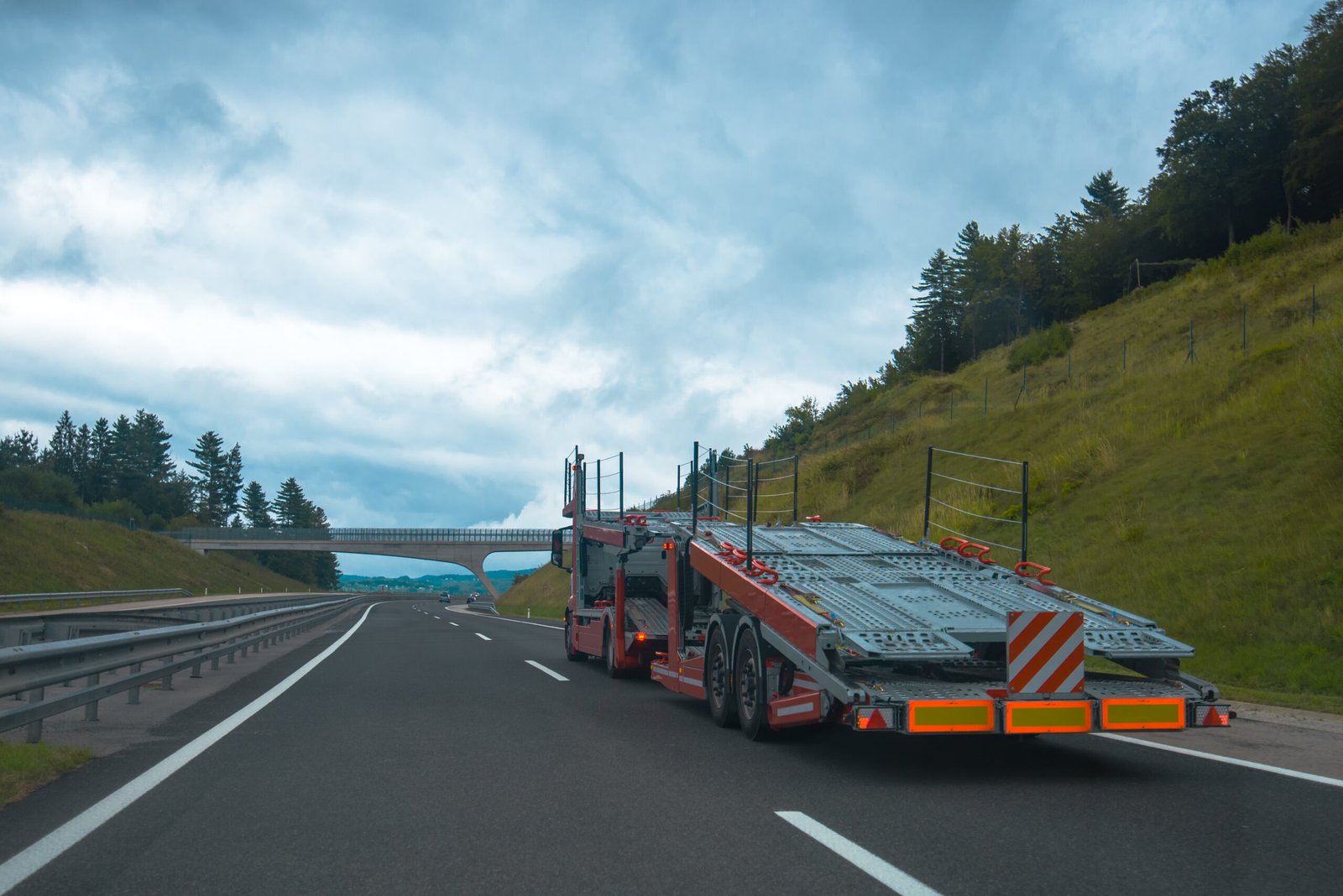 Semi truck with a car carrier trailer on the highway