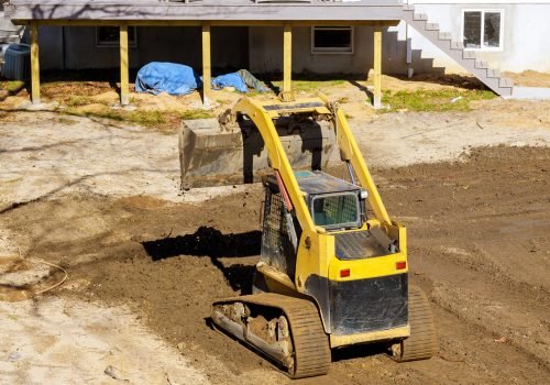 Earthmoving tractor leveling ground at a construction site