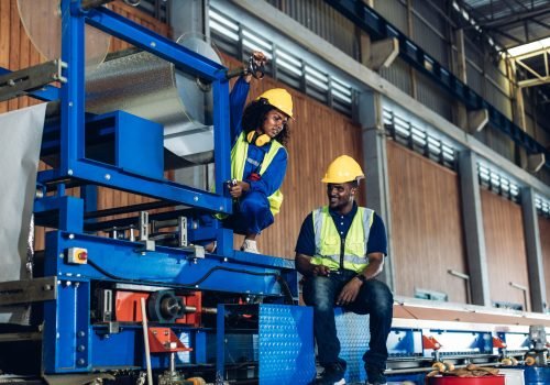 Foreman checking machinery at a factory site