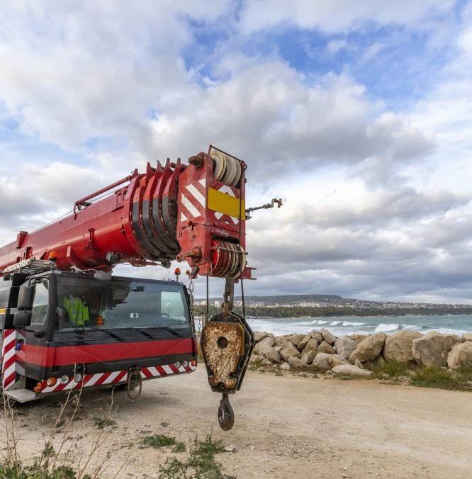Heavy duty mobile crane parked near the coast